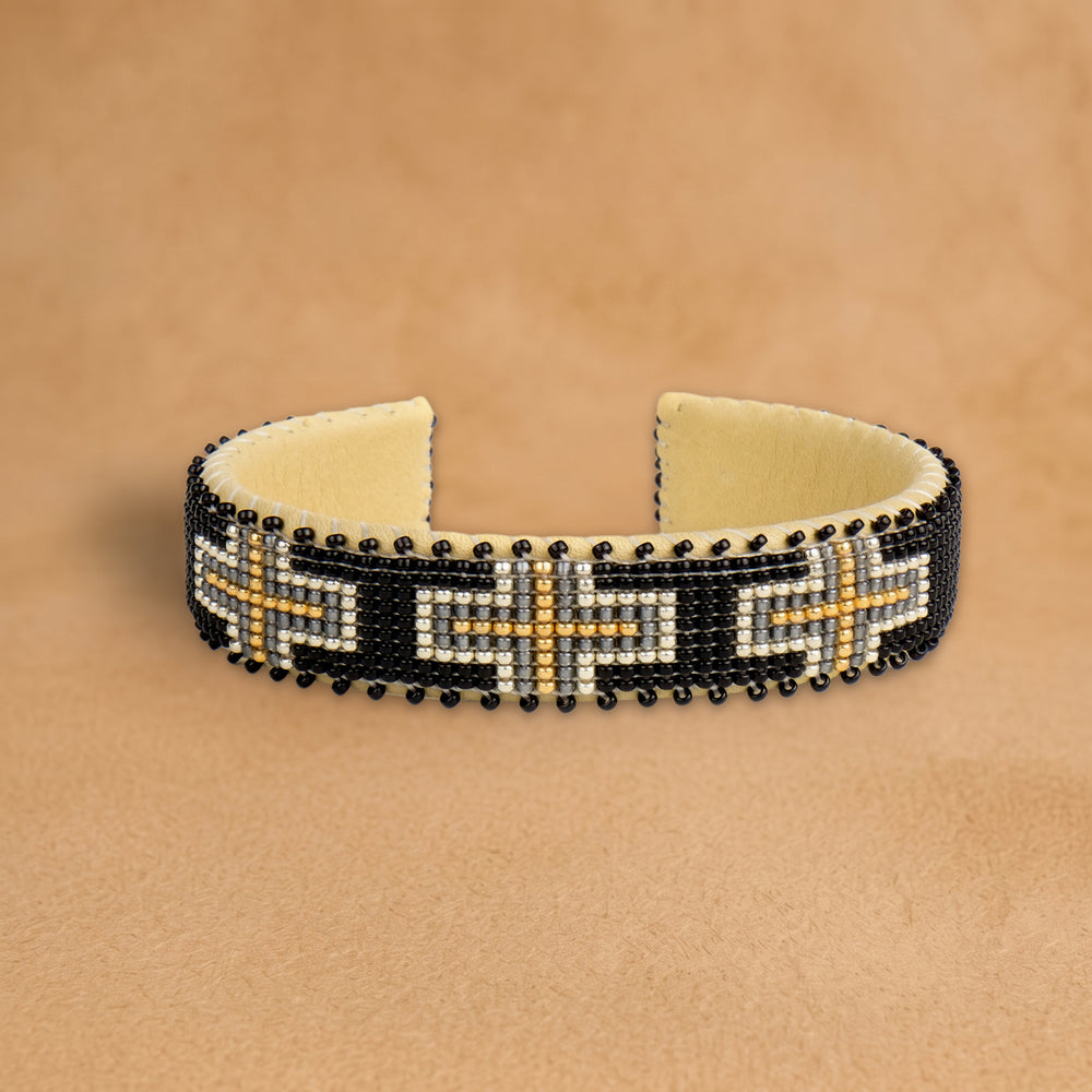 Cara Small beaded cuff, black with cream, grey and gold crosses, handloomed by Navajo artisans in New Mexico