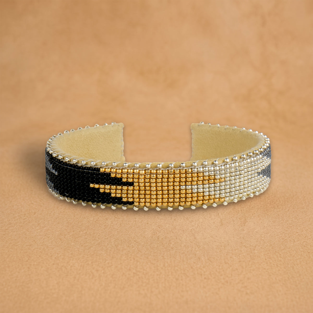Coco Small beaded cuff, white, gold and black flame pattern, handloomed by Navajo artisans in New Mexico