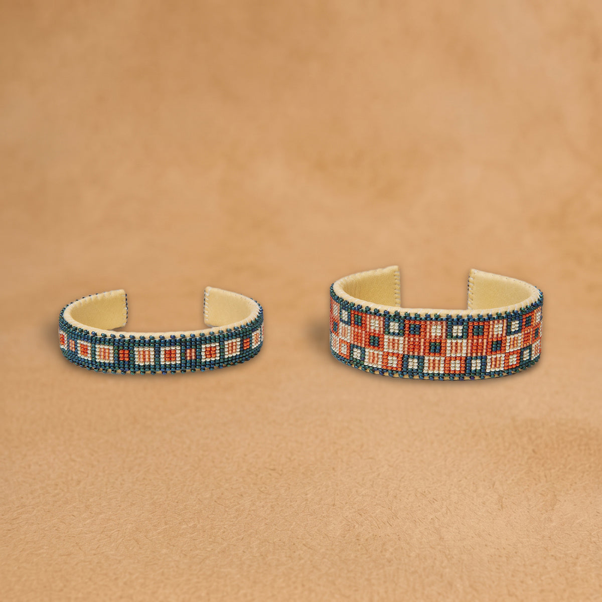 Cornflower Small and Large shown side by side, teal blue with coral and white squares, handloomed by Navajo artisans in New Mexico