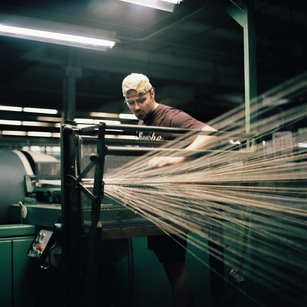 Yarn being warped on the mill floor at American Woolen Mills