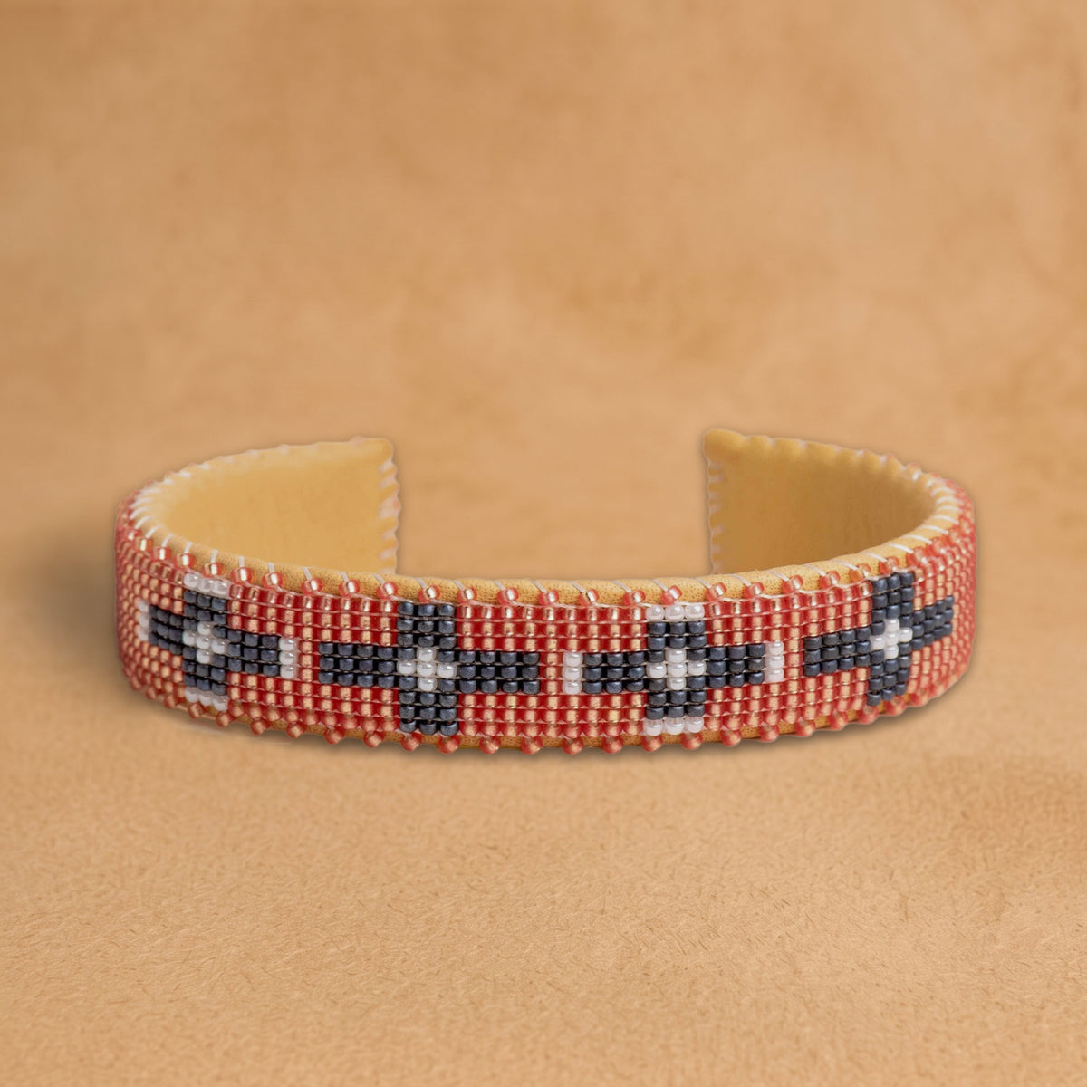Faith Small beaded cuff, coral with charcoal and white crosses, handloomed by Navajo artisans in New Mexico