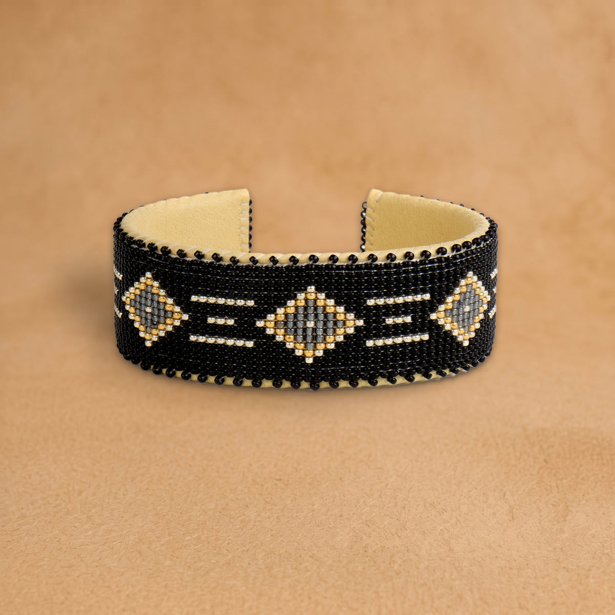 Kelly Large beaded cuff, black with grey diamonds outlined in gold and white dashes, handloomed by Navajo artisans in New Mexico