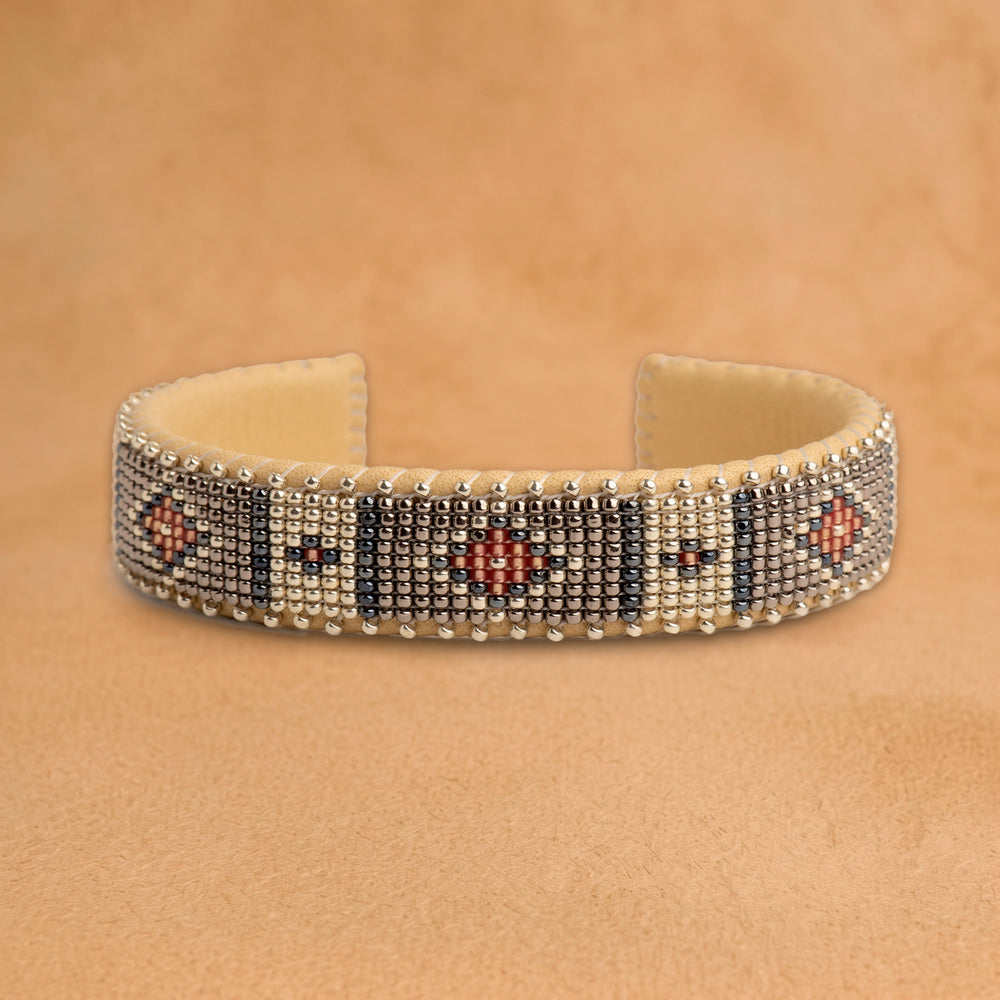 Mattie Small beaded cuff, silver and white panels with charcoal stripes and coral diamonds, handloomed by Navajo artisans in New Mexico