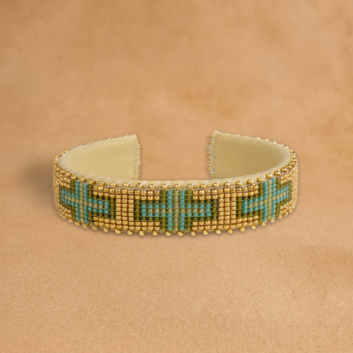 Torian Small beaded cuff, gold with turquoise and green crosses, handloomed by Navajo artisans in New Mexico